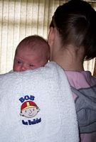 Picture of a baby and an embroidered Bob the Builder burp cloth