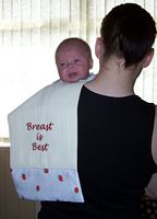 Picture of a baby and a burp cloth embroidered with the phrase Breast is best